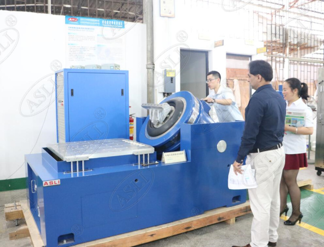 Electrodynamic vibration shaker device with magnesium alloy table and horizontal bench — front view